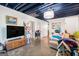 Finished basement with a dark ceiling, concrete floors, a TV, and plenty of space at 215 North Mourning Dove N Dr, Fayetteville, GA 30215