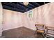 Basement featuring exposed ceiling, painted pink walls, a window, and concrete floor at 215 North Mourning Dove N Dr, Fayetteville, GA 30215