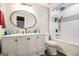 Modern bathroom featuring a white vanity, an oval mirror, white tiled shower and black accents at 215 North Mourning Dove N Dr, Fayetteville, GA 30215