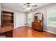 Cozy bedroom with hardwood floors, a ceiling fan, a closet, and a large window at 215 North Mourning Dove N Dr, Fayetteville, GA 30215