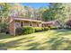Charming home with stone accents, wood siding, and a well-manicured front lawn at 215 North Mourning Dove N Dr, Fayetteville, GA 30215