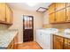 Practical laundry room with cabinetry, granite countertops, tile backsplash and washer/dryer at 215 North Mourning Dove N Dr, Fayetteville, GA 30215