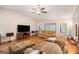 Bright living room with hardwood floors, a ceiling fan, and large windows for plenty of natural light at 215 North Mourning Dove N Dr, Fayetteville, GA 30215