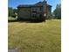 Wide backyard featuring a deck, lush green grass, and the back of the home at 220 Camerons Way, Covington, GA 30016
