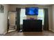 Well-lit bedroom featuring large mirror, modern dresser, and mounted television for entertainment at 220 Camerons Way, Covington, GA 30016