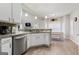 Bright kitchen features white cabinets, granite countertops, and stainless steel appliances at 220 Camerons Way, Covington, GA 30016