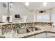 Bright kitchen features granite countertops and stainless steel sink at 220 Camerons Way, Covington, GA 30016