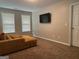 Living Room with two windows, flat screen television, and tan colored walls at 220 Camerons Way, Covington, GA 30016