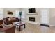 Cozy living room featuring a fireplace, plush sofas, and lots of natural light at 220 Camerons Way, Covington, GA 30016