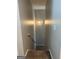 Cozy stairwell with neutral paint, carpeted stairs, and a modern light fixture enhancing the space at 220 Camerons Way, Covington, GA 30016