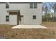 Exterior view of home, featuring a concrete patio area, and yard at 1011 Austin Rd, Ellenwood, GA 30294