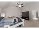 Spacious bedroom featuring vaulted ceiling, ceiling fan, plush carpet, and large screen television at 1011 Austin Rd, Ellenwood, GA 30294
