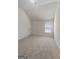 Neutral bedroom featuring plush carpeting, white walls, and a window that allows natural light at 1011 Austin Rd, Ellenwood, GA 30294