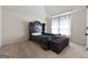 Bedroom with vaulted ceilings, carpet and a large, dark wood decorative headboard at 1011 Austin Rd, Ellenwood, GA 30294