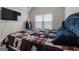 Cozy bedroom featuring a comfortable bed, a mini-fridge, and a window for natural light at 1011 Austin Rd, Ellenwood, GA 30294