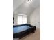 Bedroom with vaulted ceilings, carpet and a large, dark wood decorative headboard at 1011 Austin Rd, Ellenwood, GA 30294