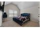 Cozy bedroom featuring a comfortable bed, a mini-fridge, and a window for natural light at 1011 Austin Rd, Ellenwood, GA 30294
