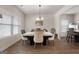 Bright dining room with a marble table and chairs below a chandelier at 1011 Austin Rd, Ellenwood, GA 30294