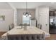 A dining room with stylish chairs, marble table top, and elegant chandelier lighting at 1011 Austin Rd, Ellenwood, GA 30294