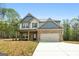 Well-maintained two-story home with brick accents, a two-car garage, and a manicured lawn in a quiet setting at 1011 Austin Rd, Ellenwood, GA 30294