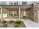 Inviting front porch with brick columns, neutral trim, and landscaping at 1011 Austin Rd, Ellenwood, GA 30294