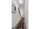 Bright hallway featuring modern lighting, neutral walls, and an accent rug leading to the stairs at 1011 Austin Rd, Ellenwood, GA 30294