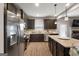 Spacious kitchen featuring wood floors, stainless appliances, granite counters, and dark cabinets at 1011 Austin Rd, Ellenwood, GA 30294