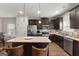 A modern kitchen features stainless appliances, an island, and dark wood cabinets at 1011 Austin Rd, Ellenwood, GA 30294