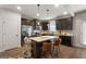 Modern kitchen with dark cabinets, stainless steel appliances, granite countertops, and an island with bar seating at 1011 Austin Rd, Ellenwood, GA 30294