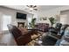 Comfortable living room with leather couches, a fireplace, a ceiling fan, and plush reclining chairs at 1011 Austin Rd, Ellenwood, GA 30294