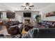 Cozy living room featuring leather sofas, a fireplace, a ceiling fan, and an accent rug at 1011 Austin Rd, Ellenwood, GA 30294