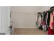 Spacious walk-in closet with carpet flooring, wire shelving and hanging racks for ample storage at 1011 Austin Rd, Ellenwood, GA 30294