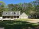 Lovely home with a spacious front yard and a welcoming front porch and two-car garage at 4430 Kings Hwy, Douglasville, GA 30135