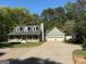 Charming home featuring a welcoming front porch and a convenient two-car garage at 4430 Kings Hwy, Douglasville, GA 30135