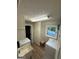 This bright laundry room includes a utility sink, washer, dryer, and storage cabinets at 4430 Kings Hwy, Douglasville, GA 30135