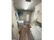 This bright laundry room includes a utility sink, washer, dryer, and storage cabinets at 4430 Kings Hwy, Douglasville, GA 30135