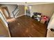 Spacious living room with hardwood floors, staircase access, and study area with natural light at 4430 Kings Hwy, Douglasville, GA 30135