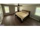 This main bedroom boasts hardwood floors, ceiling fan, and natural light from the many windows at 4430 Kings Hwy, Douglasville, GA 30135