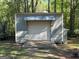 A functional outbuilding with a roll-up door, ideal for storage or a workshop at 4430 Kings Hwy, Douglasville, GA 30135