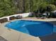 Enjoy this backyard pool with concrete surround and white fence at 4430 Kings Hwy, Douglasville, GA 30135