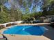 Enjoy this backyard pool with concrete surround, white fence, and mature trees at 4430 Kings Hwy, Douglasville, GA 30135