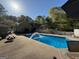 A refreshing pool with a water feature, surrounded by a patio and mature trees at 4430 Kings Hwy, Douglasville, GA 30135