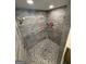 This shower features a pebble floor and grey textured tile surround at 4430 Kings Hwy, Douglasville, GA 30135