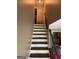 Elegant stairway featuring neutral wall colors and a contrasting white staircase leading to the upper level at 4430 Kings Hwy, Douglasville, GA 30135