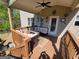 Outdoor seating on covered back porch with ceiling fan at 1007 Oglethorpe Ct, Woodstock, GA 30188