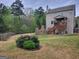 Backyard features outdoor fireplace and covered back porch with stairs at 1007 Oglethorpe Ct, Woodstock, GA 30188