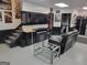 Finished basement with a large flatscreen TV, gas fireplace, leather sofa, and modern decor at 1007 Oglethorpe Ct, Woodstock, GA 30188
