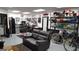 Basement features a seating area, bike racks, workspace, refrigerator, custom wall decor, and painted floors at 1007 Oglethorpe Ct, Woodstock, GA 30188