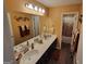 Well-lit bathroom featuring a double vanity, large mirror, and stylish decor accents at 1007 Oglethorpe Ct, Woodstock, GA 30188