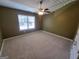 Bright bedroom with a ceiling fan and a large window offering natural light at 1007 Oglethorpe Ct, Woodstock, GA 30188